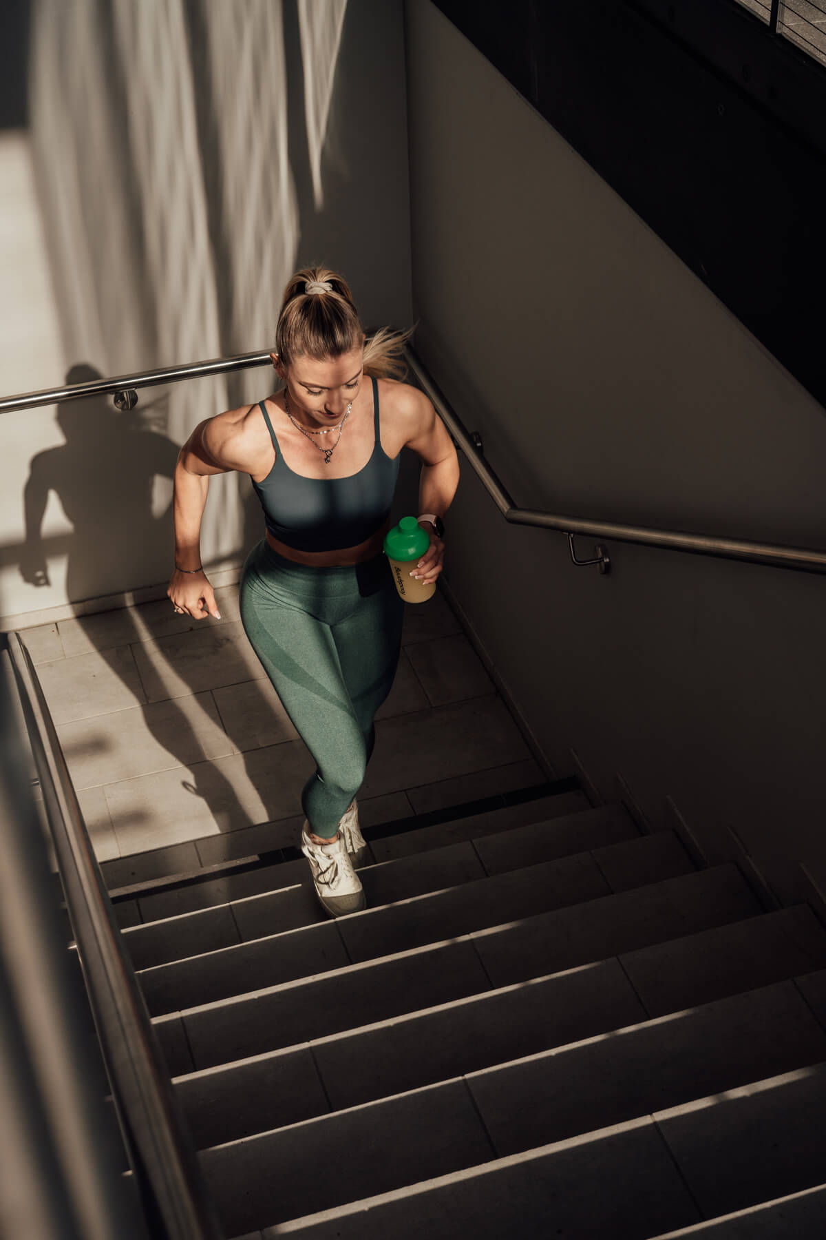 Coach Steffi running up the stairs